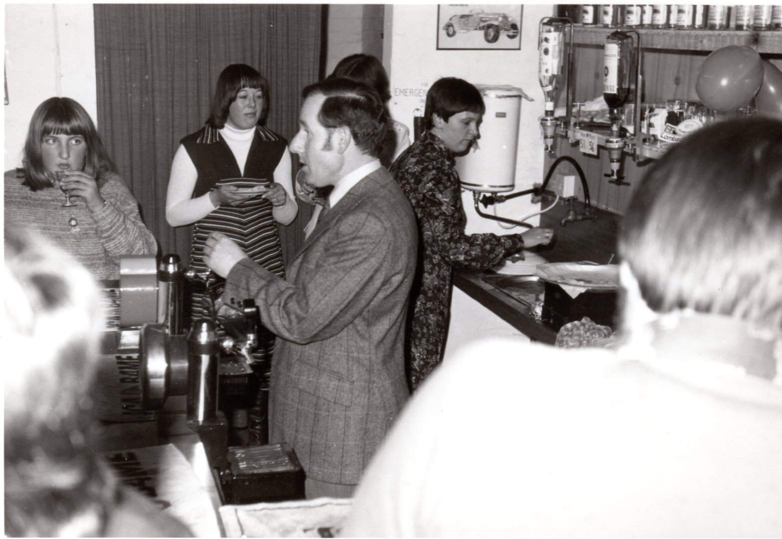Brenda Cartwright with back to the curtain, David Carbert and Sue Cobley at the sink.